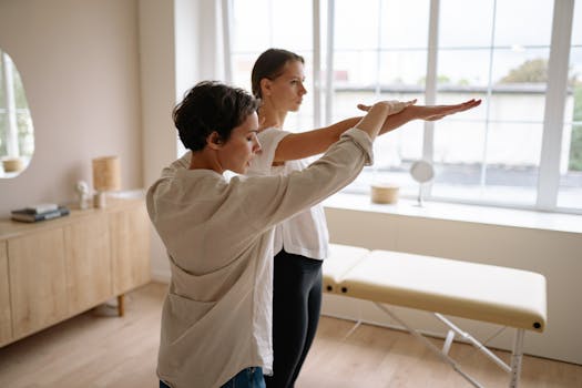 A therapist helps a client with therapeutic exercises in a wellness clinic.